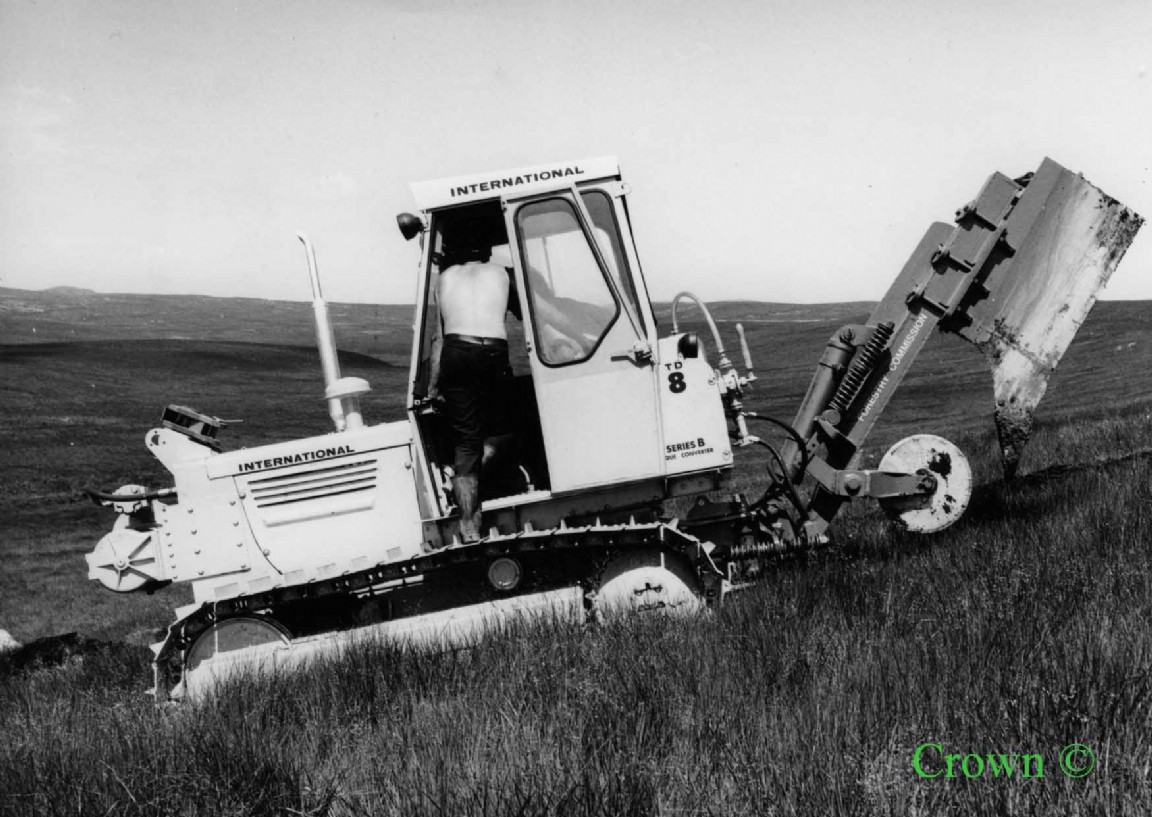 International TD8 with mounted tine plough