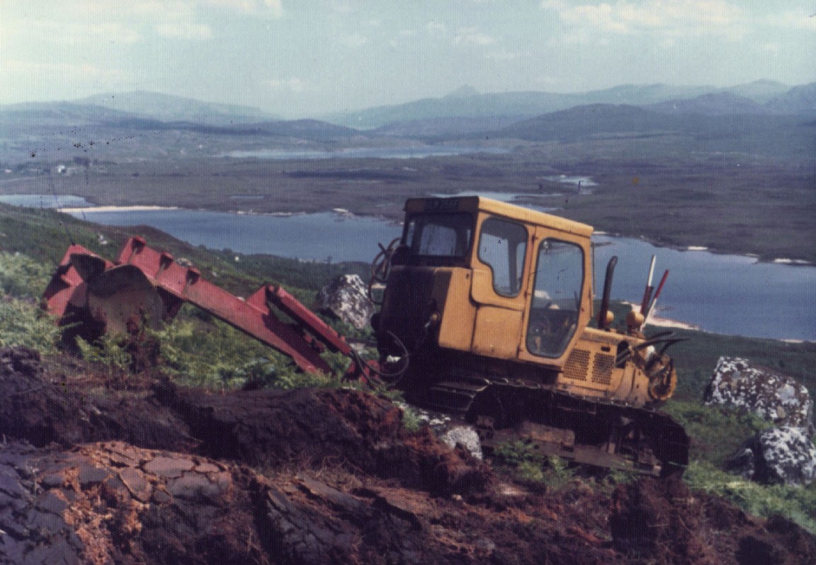 BTD8 (possibly) with mounted tine Ploughing in very scenic location