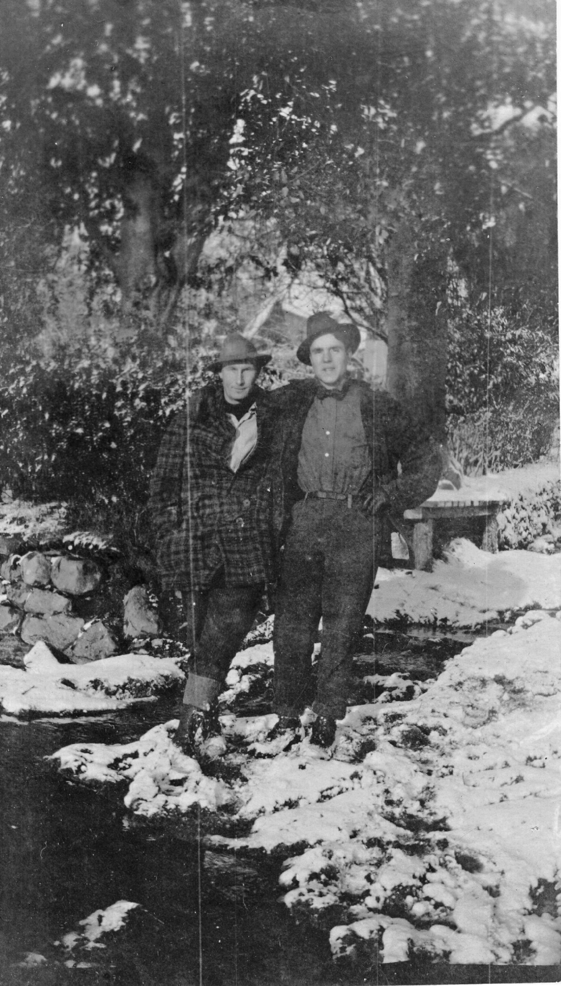 Lacy Judkins (on left) and Lovell Churchill in front of large holly trees near Creich, Bonar Bridge 1917