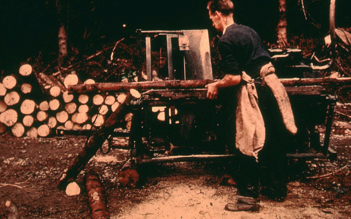 Cross cutting on swing table saw bench circa 1955